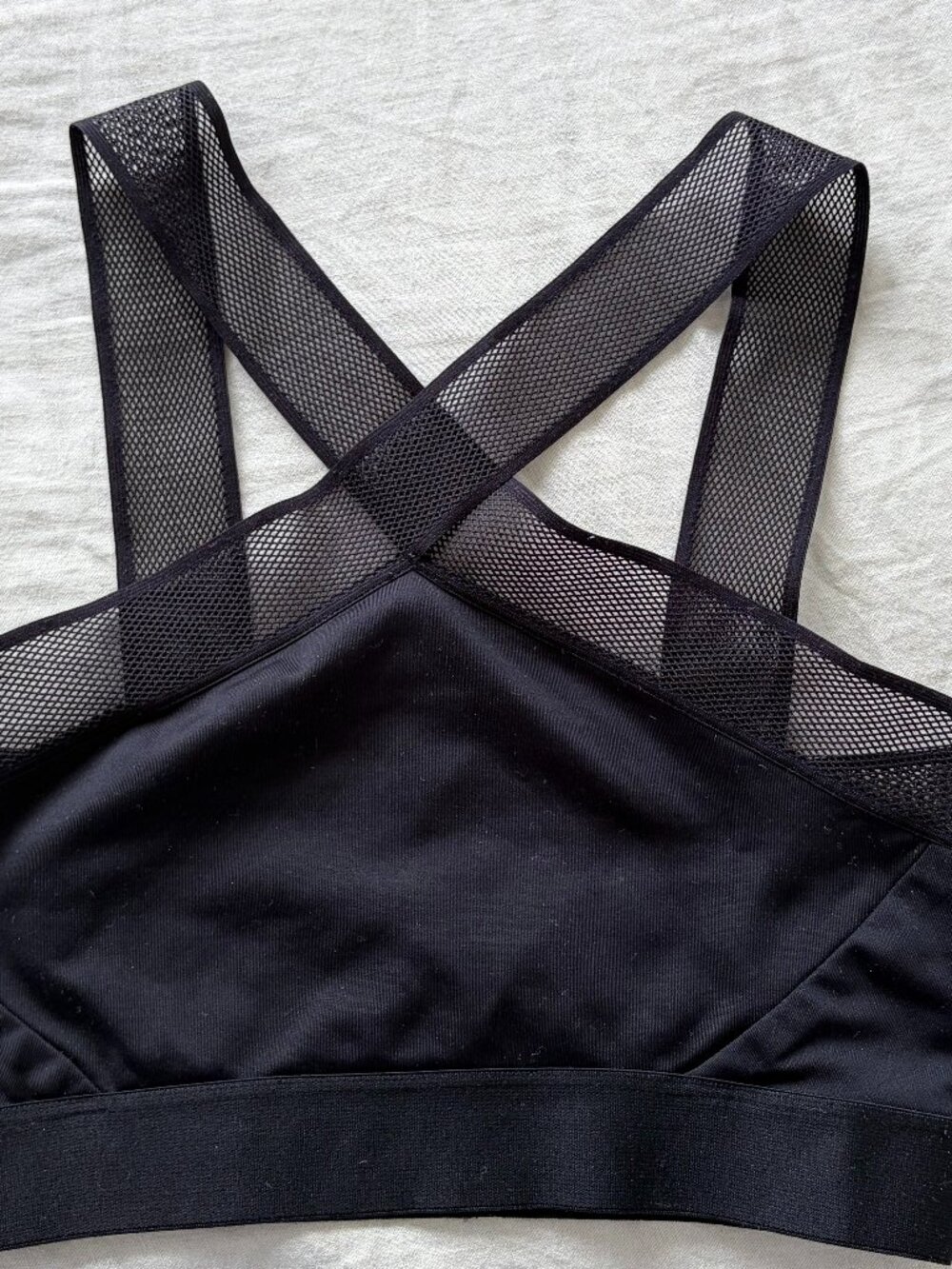 Black halter sports bra with mesh accent lining